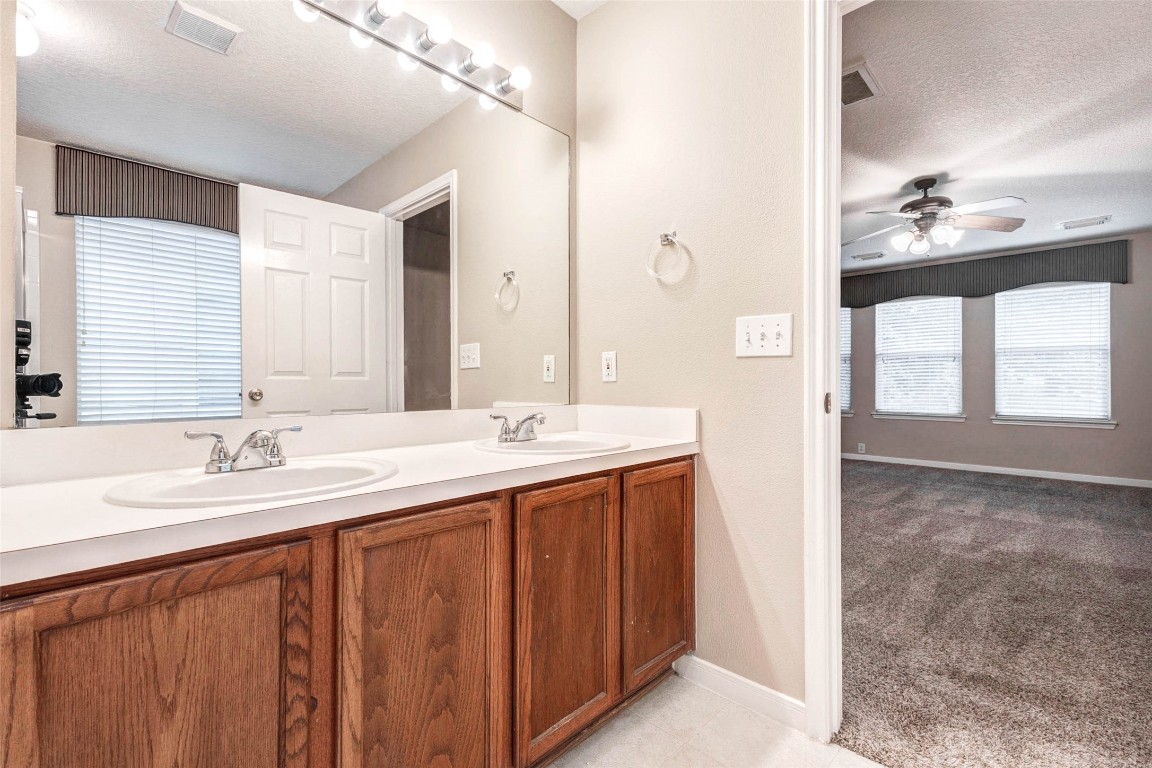 18327 Atasca Wds Trace Humble, TX 77346 - Photo 17 of 28 a bathroom with a double vanity sink and a mirror