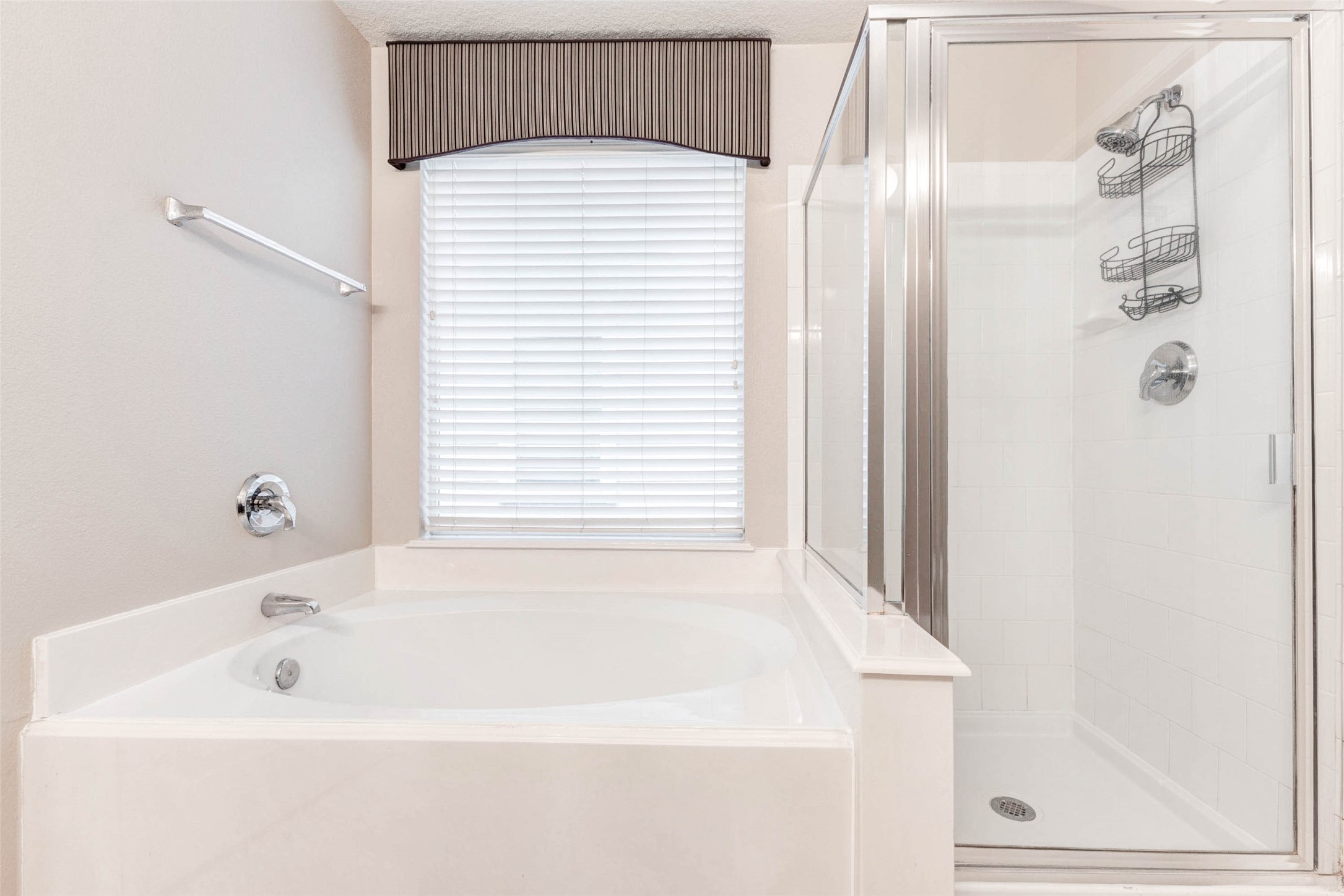 18327 Atasca Wds Trace Humble, TX 77346 - Photo 18 of 28 a bathroom with a bathtub and a shower