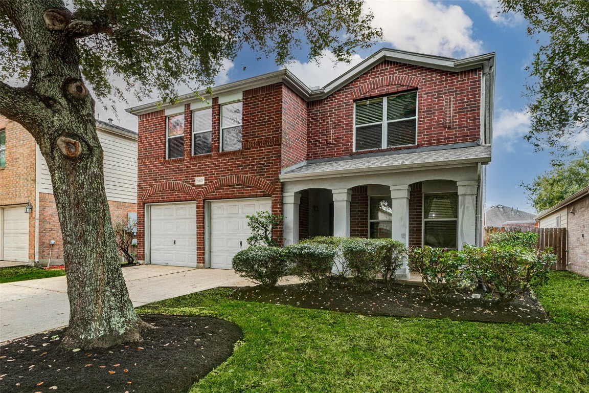 18327 Atasca Wds Trace Humble, TX 77346 - Photo 2 of 28 a front view of a house with garden