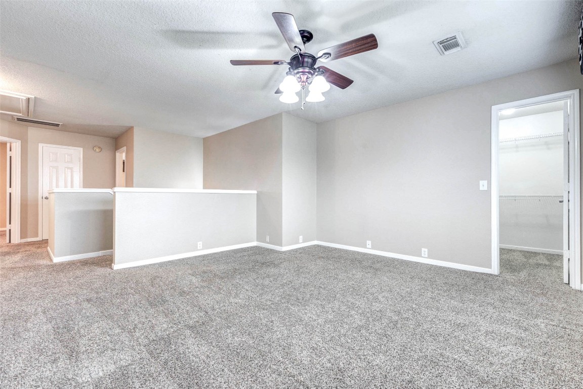 18327 Atasca Wds Trace Humble, TX 77346 - Photo 21 of 28 a view of an empty room with a ceiling fan