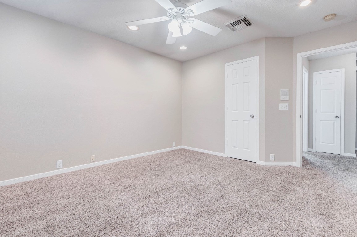 18327 Atasca Wds Trace Humble, TX 77346 - Photo 23 of 28 an empty room with a chandelier fan and closet area