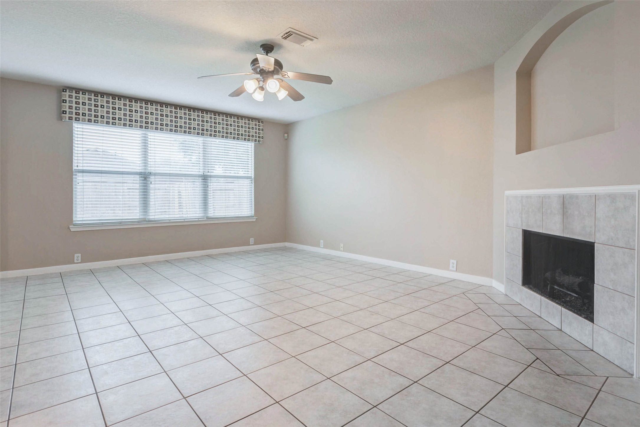 18327 Atasca Wds Trace Humble, TX 77346 - Photo 5 of 28 an empty room with windows and fireplace