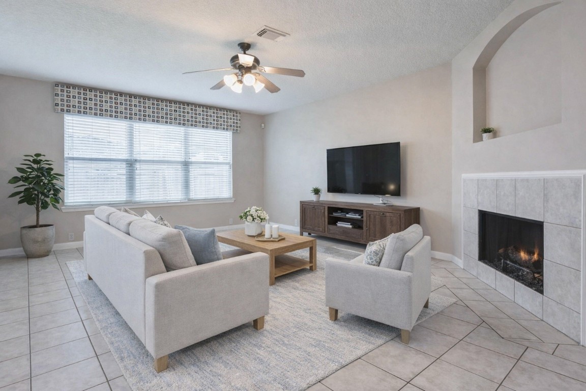 18327 Atasca Wds Trace Humble, TX 77346 - Photo 6 of 28 a living room with furniture a fireplace and a flat screen tv