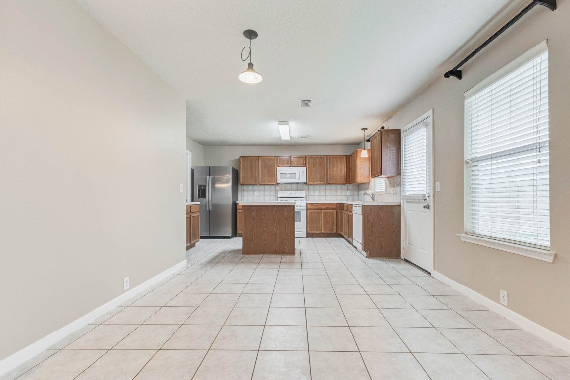 18327 Atasca Wds Trace Humble, TX 77346 - Photo 9 of 28 a large kitchen with stainless steel appliances lots of counter top space and windows