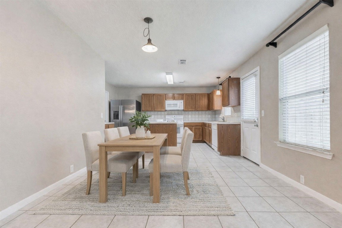 18327 Atasca Wds Trace Humble, TX 77346 - Photo 10 of 28 a dining room with furniture and window