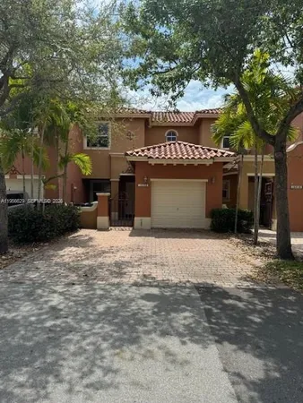 a view of a house with a yard and garage