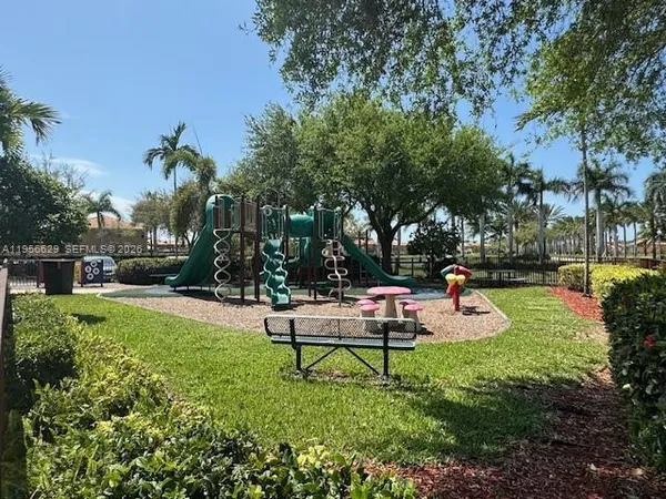 a view of swimming pool with outdoor seating and yard in back