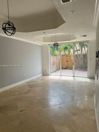 a view of a room with wooden floor and windows
