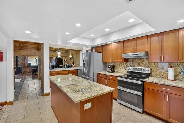 a kitchen with a table chairs stove and sink