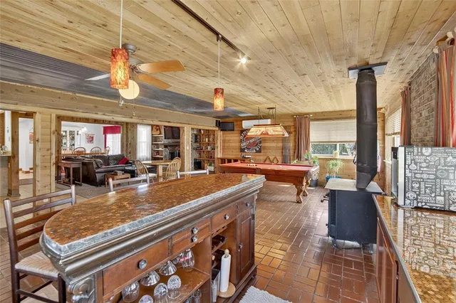 a bathroom with a granite countertop shower and a toilet