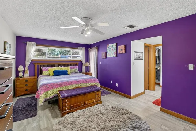a white toilet sitting next to a bathroom sink and vanity