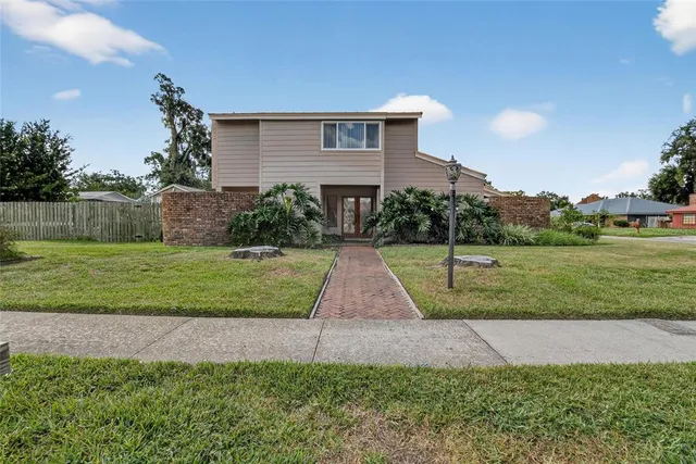 a view of a house with a backyard and sitting area