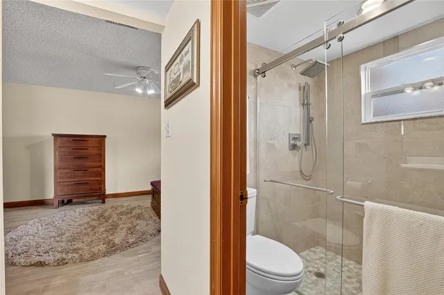 a living room with a black white checkered floor with a gaming machine and dining chairs
