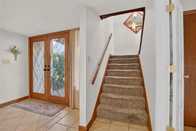 an aerial view of a house with garden space and street view