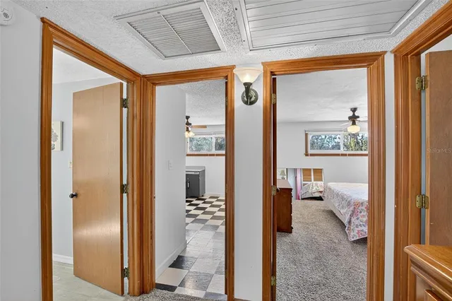 an aerial view of residential houses with outdoor space and trees