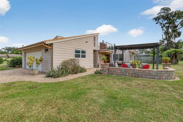 a view of an outdoor sitting area with furniture and garden view