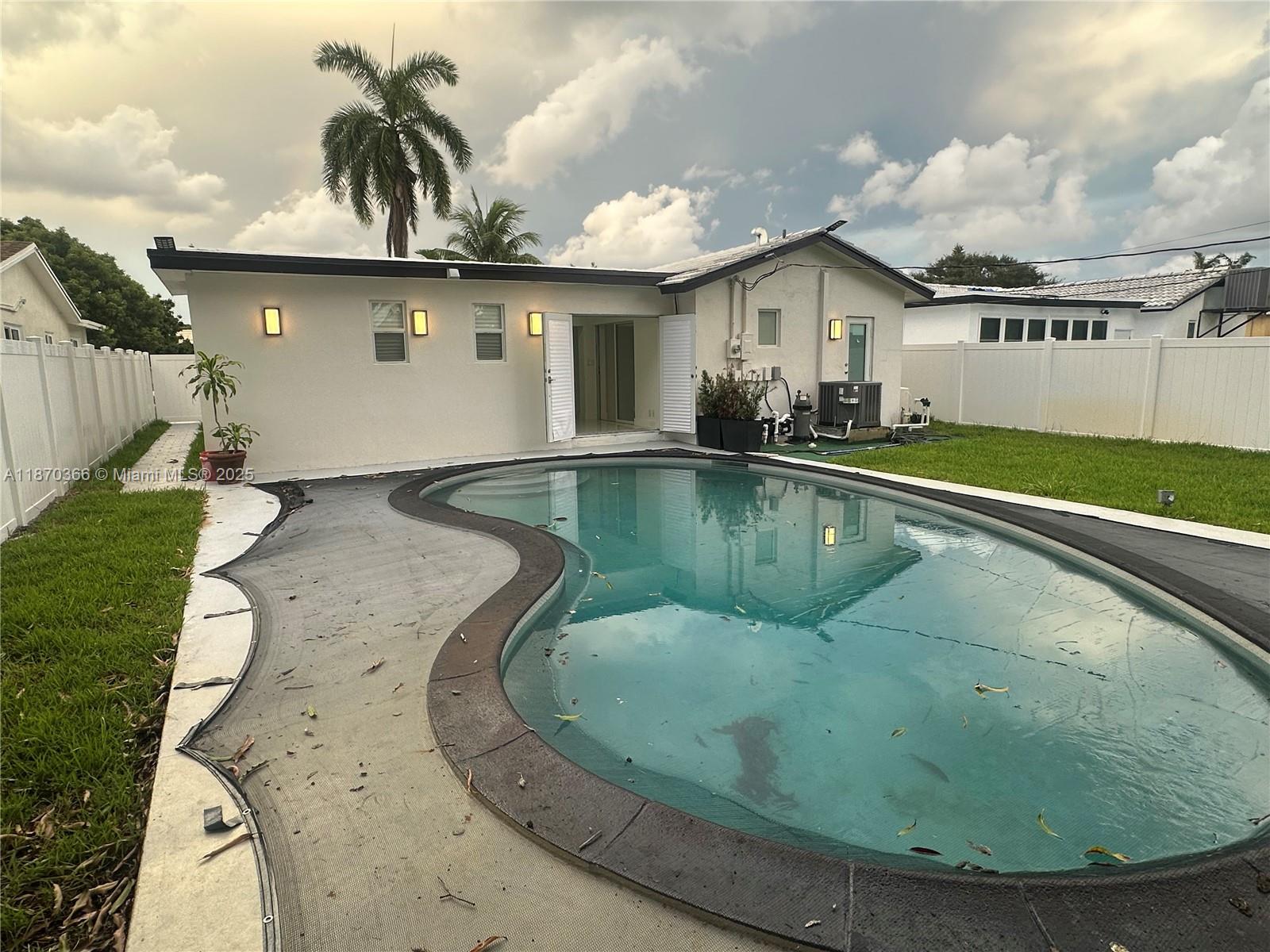 526 South Rainbow Drive Hollywood, FL 33021 - Photo 18 of 20 a view of a house with a swimming pool