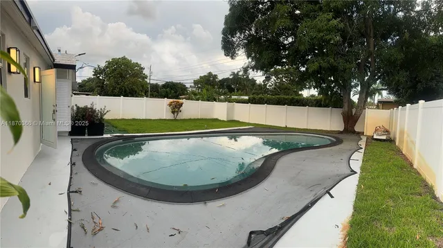 a view of a swimming pool with a yard