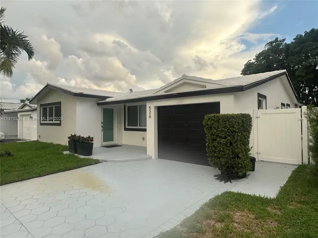 a view of a house with a yard and a garage