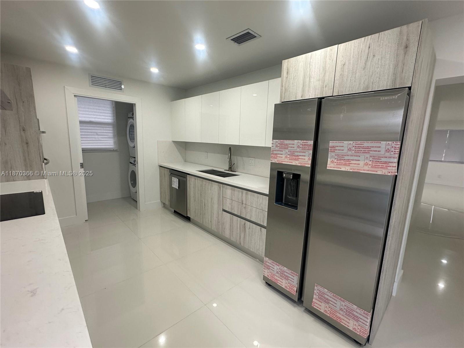 526 South Rainbow Drive Hollywood, FL 33021 - Photo 5 of 20 a kitchen with stainless steel appliances a refrigerator and a sink