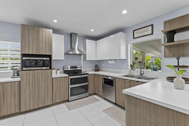 a kitchen with stainless steel appliances granite countertop a sink and cabinets
