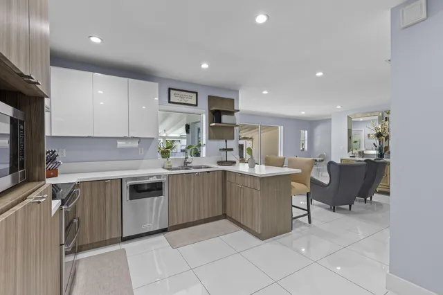 a kitchen with a sink and chairs
