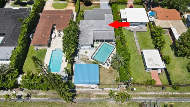 an aerial view of residential house with outdoor space and swimming pool