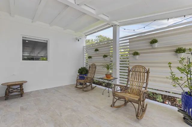 a living room with furniture potted plant and a chandelier