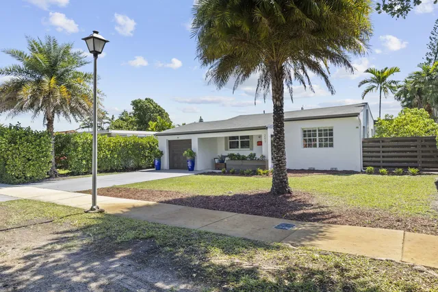 a house with palm tree in front of it