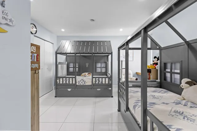 a bedroom with furniture and a book shelf