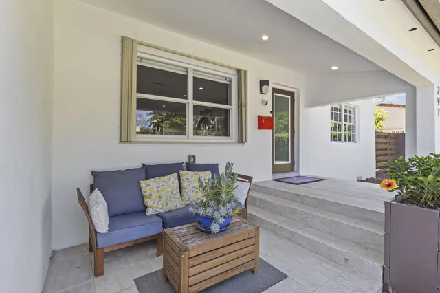 a living room with furniture and flowers