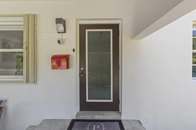 view of a hallway with wooden floor and a door