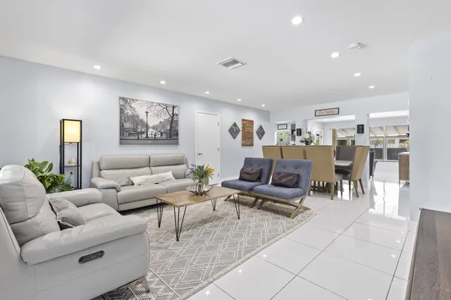 a living room with furniture and kitchen view