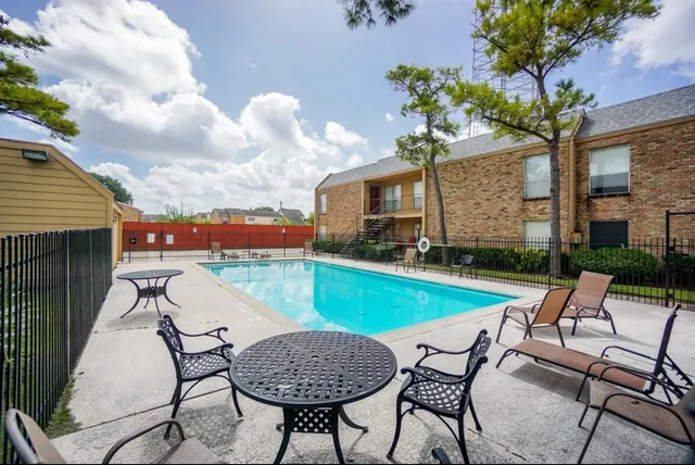 a swimming pool with outdoor seating and yard