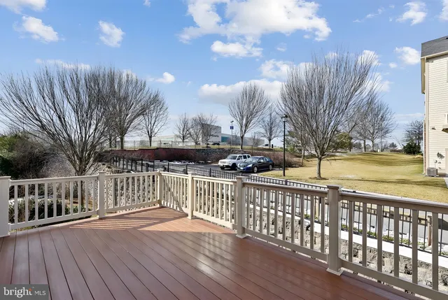 a view of a big room with windows and chandelier fan