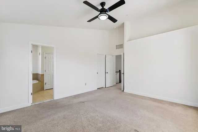 a front view of a residential apartment building with a yard