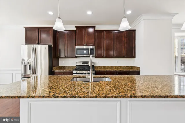 a view of empty room with wooden floor and windows