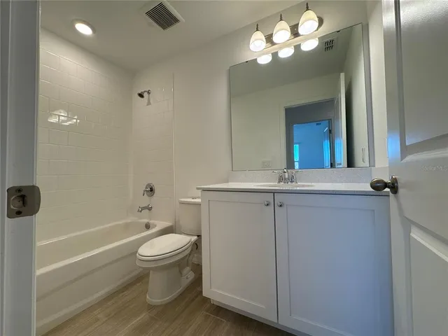 a bathroom with a toilet a sink and bathtub
