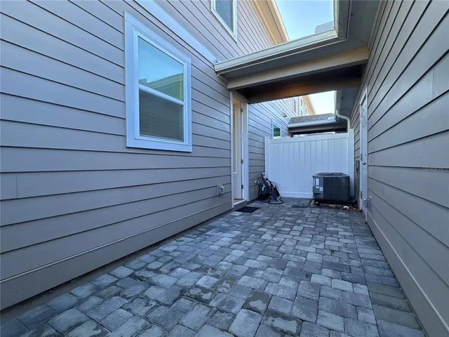 a view of a house with a door and wooden walls