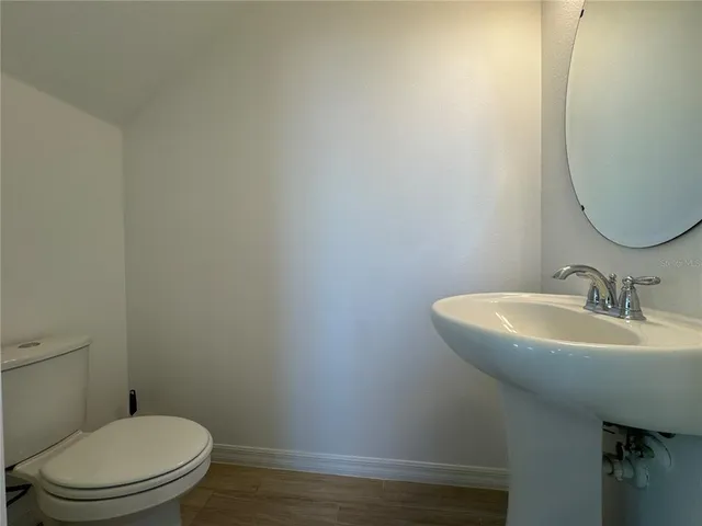 a view of a garden with a houses in the background