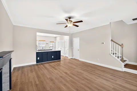 a living room with furniture and a ceiling fan