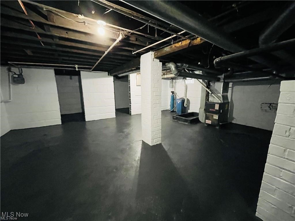 2511 4th Street Northwest Canton, OH 44708 - Photo 19 of 20 Unfinished basement featuring heating unit and a water pressure tank