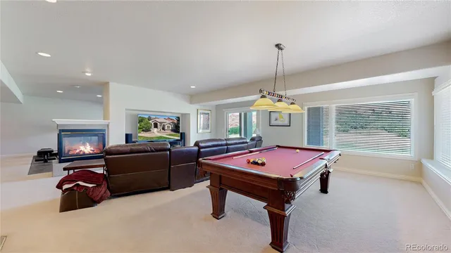 a room with furniture and pool table