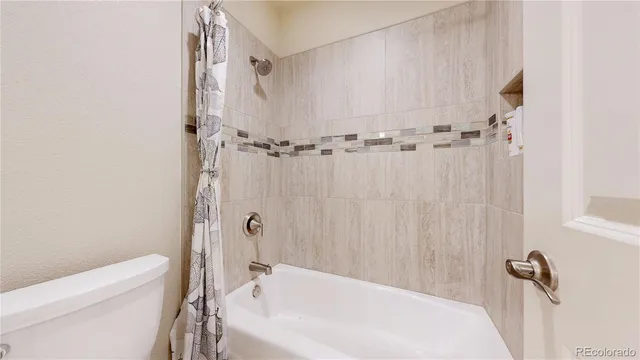 a bath tub sitting next to a white toilet and sink