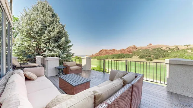 a view of a patio with couches chairs and wooden floor