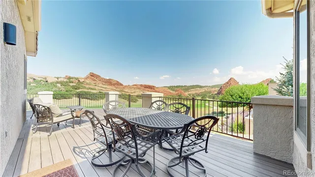 a view of a balcony with furniture and a floor to ceiling window