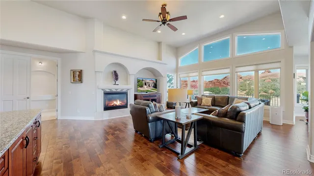 a living room with fireplace furniture and a wooden floor