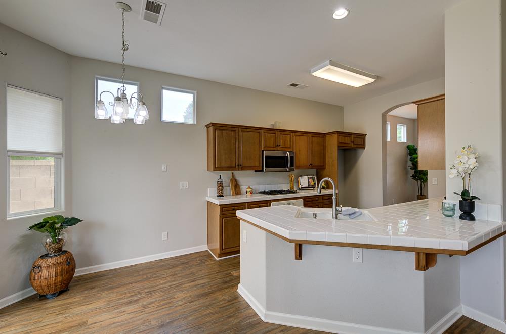 3235 Rall Avenue Clovis, CA 93619 - Photo 3 of 33 a kitchen with a sink and chandelier