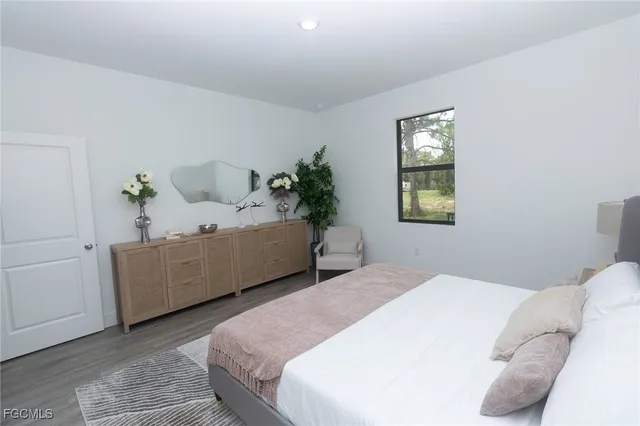 a bedroom with a bed and a potted plant