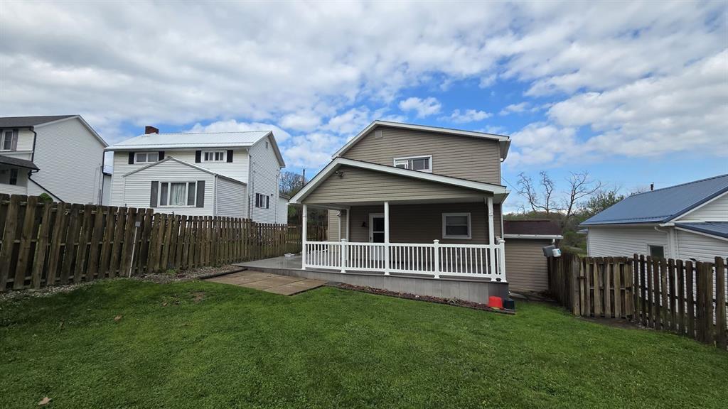 725 Longfellow Street Vandergrift, PA 15690 - Photo 11 of 14 a front view of a house with garden